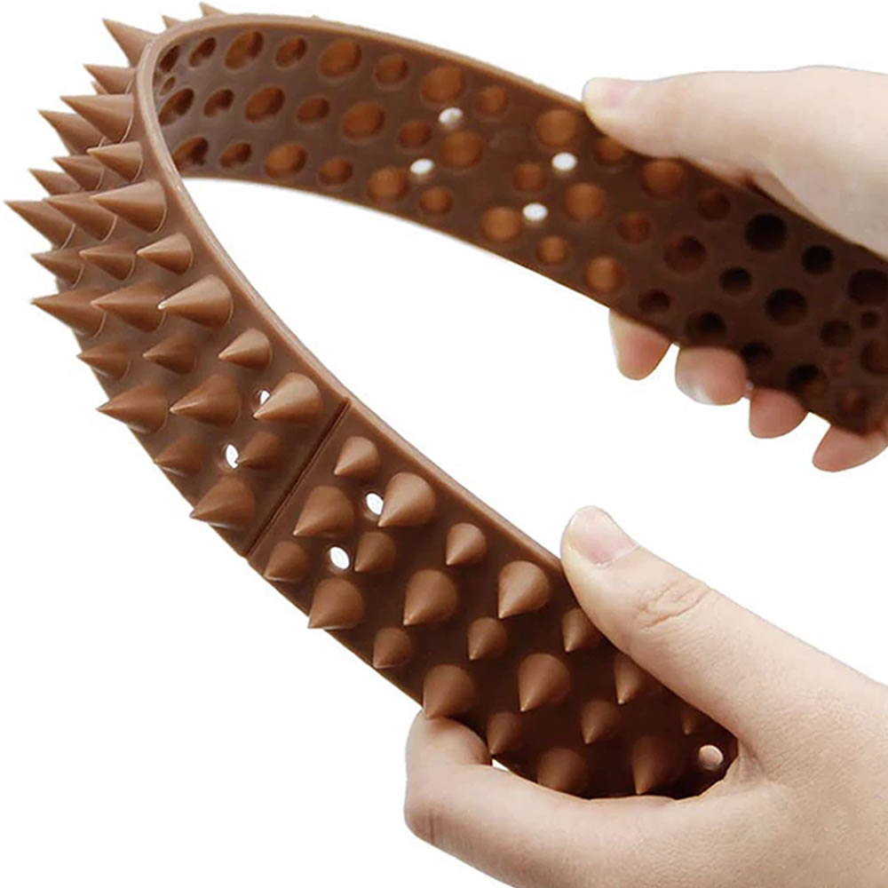 A moulded plastic spike strip on a fence rail